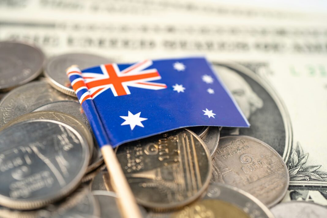 Stack of coins with Australia flag on white background.